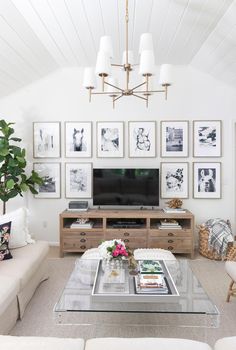 a living room with pictures on the wall and a television in the centerpieces