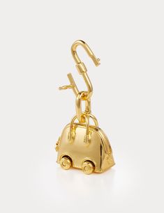 Inspired by Hermes Bolide On Wheels Bag Charm, Aelysee has meticulously crafted the Mini Bolide On Wheels Bag Charm, incorporating unique design elements. The charm features a separate clasp and chain, allowing you to customize it effortlessly with any of your handbags. Electroplated brass Charm size - 30 x 18.3 x 28.8mm Total weight 38g One year warranty Luxury Small Travel Bags, Small Elegant Travel Bag, Small Luxury Bags, Gold Travel Bag With Lock, Elegant Gold Bag Charm As Gift, Modern Gold Bag With Lock, Elegant Bag Charm With Lobster Clasp As Gift, Elegant Bag Charm With Lobster Clasp For Gift, Elegant Bag Charm For Everyday Use