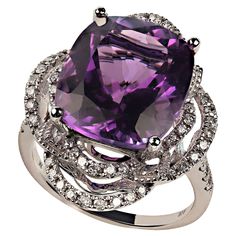 Delightful cocktail ring of cushion cut Amethyst, 7.63ct, in 14K white gold setting featuring 0.61ct of Diamonds. The two looping halos of Diamonds create an elegant and dramatic setting for this lovely Amethyst. The diamonds continue down the top of the shank of the ring. No changes by seller. This is a sizable 6.5 which your local jeweler can assist you with if you should need to size. MR2350 Luxury Purple Gemstones With Halo Setting, Wedding Amethyst Gemstones With Diamond Accents, Luxury White Gold Amethyst Ring With Gemstone Accents, Luxury Purple Rings For Party, Luxury Purple Party Rings, Elegant Evening Rings With Center Stone, Luxury Purple Sapphire Ring, Luxury Amethyst Ring With Halo Setting, Luxury White Gold Amethyst Ring With Halo Setting