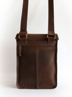 a brown leather bag with two straps hanging from it