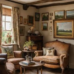 a living room filled with furniture and paintings on the wall above it's windows