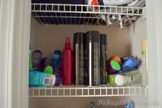 there are many items in the closet on this shelf, including shampoos and toothbrushes