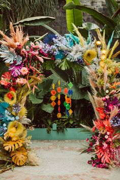 an arrangement of colorful flowers and plants on display