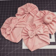 three pink bows on top of a piece of cloth