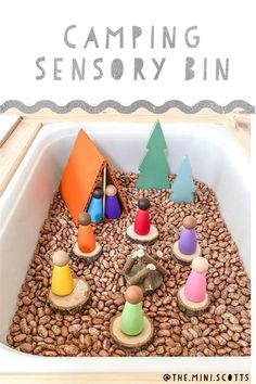 a close up of a bowl of food with toys in it and text reading camping sensory bin