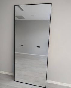 an empty room with a large mirror on the wall