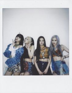 four girls posing in front of a white wall with their hands on their hipss