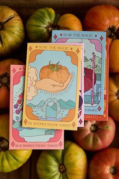 two tarot cards sitting next to some pumpkins