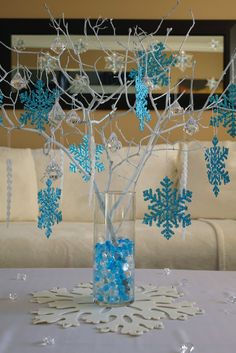 a vase filled with blue snowflakes sitting on top of a table