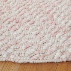 a pink and white rug on the floor