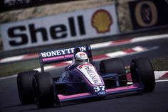 a man driving a racing car down a race track