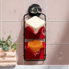 soaps are sitting on the wall next to a towel rack