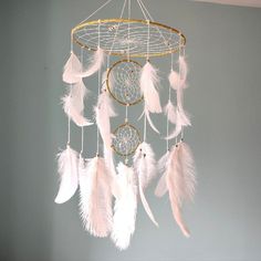 a white dream catcher hanging from the ceiling