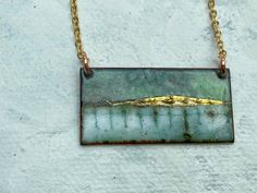 "Landscape inspired enamel rectangle necklace on a 18\" delicate gold plated chain. The pendant measures approximately 30mm x 15mm . Layers of vitreous enamel were used to build up the depth and variation in colour over a number of firings, 24ct gold foil added at the final stage to produce a 'watercolour' effect landscape. Each piece is unique and variations are dependent on firing times and interactions between the properties of different enamels. The back of the pendant has been enamelled for Rectangular Patina Jewelry As Gift, Rectangle Necklace, Vitreous Enamel, Enamel Necklaces, Bib Necklaces, Enamels, Gold Plated Chains, Gold Plated Sterling Silver, Gold Foil