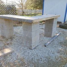 two concrete benches sitting on top of gravel