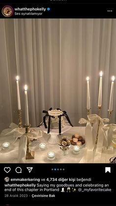 a table topped with lots of candles next to a cake and cupcake on top of it