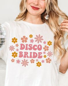 a woman wearing a disco bride t - shirt with flowers on the front and back