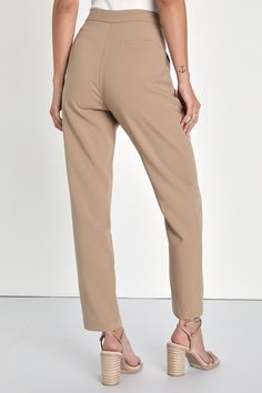 From the desk to after-hours fun, the Lulus Chic Business Khaki High-Waisted Trouser Pants will have you looking fab! Stretch-woven fabric shapes these chic trousers with a seamed detail that travels down the tapered legs to ankle-length hems. Functional side pockets frame the high waistband that has a hidden fly with clasp closure and top button, while a decorative welt pocket adorns the back. Fit: This garment fits true to size. Length: Ankle length. Size medium Inseam: 28.00 Front Rise: 11.75 Beige Tapered Leg Bottoms For Work, Beige Dress Pants With Elastic Waistband For Work, Non-stretch Dress Pants With Elastic Waistband For Work, Beige Tapered Leg Dress Pants For Office, Trendy Office Wear Trousers, Beige Stretch Bottoms For Office, Beige Office Wear Bottoms, Beige Stretch Tapered Leg Dress Pants, Workwear Bottoms With Elastic Waistband And Tapered Legs