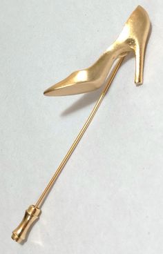 Vintage Brushed Gold Tone High Heel Shoe Pin Brooch; Gold Tone Shoe Lapel Pin; High Heel Shoe Jewelry; Gold Tone High Heel Shoe Stick Brooch This is a lovely stick pin brooch.  Has a lovely brushed gold tone high heel shoe as the main focus piece.  This shoe measures 1 1/4" x 1".  Pin measures 3 1/4" long.  Has a beautiful gold brushed finish.  Very classy and super nice quality.  Preowned gently worn with little to no wear.  See pics for details. ** I offer combined shipping 4.00 first item and .50 each additional item. Free Shipping for orders totaling $35.00 or more. https://flipnfound.etsy.com for my other items! Pre-owned. This jewelry has been previously worn and is free from any major damage such as missing stones, broken pieces, large dents, etc. All pre-owned jewelry may include g Vintage Brush, Broken Pieces, Stick Pins, Jewelry Gold, Lapel Pin, Pin Brooch, Lapel Pins, High Heel Shoes, High Heel