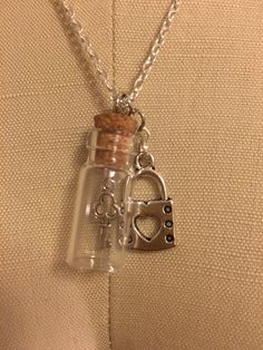 "Necklace with a key in a glass bottle with a lock Silver chain 19\" in length Glass Bottle 1.25\" in length" Lock And Key Necklace, Under Lock And Key, Astoria Ny, Key Necklace, Lock And Key, Glass Bottle, Make And Sell, Glass Bottles, Charm Necklace