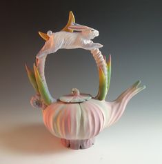 a ceramic teapot shaped like a fish with its mouth open