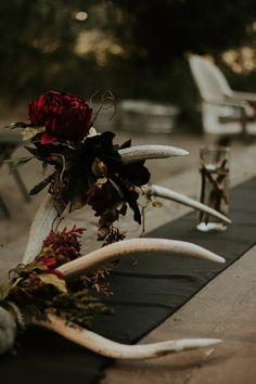 flowers and antlers are placed on the table