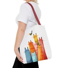 Brighten up your day with this adorable cat tote bag! Featuring a playful design of colorful cats and a cheerful bird, this bag is perfect for carrying your essentials while adding a touch of fun to your outfit. Made with durable materials, this tote is both stylish and functional. Key Features: Cute and colorful cat design High-quality, durable materials Spacious interior for plenty of storage    Perfect for everyday use or special occasions Order yours today and bring a little joy wherever you Playful Rectangular Bag With Cat Design, Cute Colorful Bags For Everyday Use, Cute Multicolor Canvas Bag For Everyday Use, Playful Multicolor Shoulder Bag For Everyday, Playful Multicolor Bags With Cat Design, Casual Multicolor Shoulder Bag With Cat Design, Casual Multicolor Cat Design Shoulder Bag, Daily Use Multicolor Bags With Animal Design, Travel Tote Canvas Bag With Cat Design