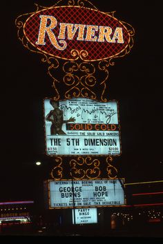 the riviera theatre sign is lit up at night