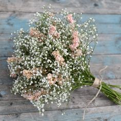 a bouquet of baby's breath sitting on top of a wooden table