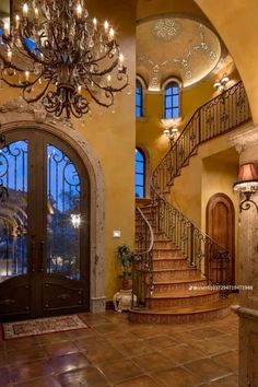 a large foyer with chandelier and stairs