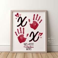 two hand prints with the words love and kisses written on them in red ink, against a white background