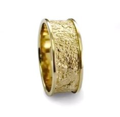 a gold wedding ring with an intricate design on the outside and inside, set in 18k yellow gold