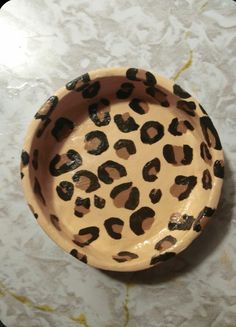 a leopard print bowl sitting on top of a table