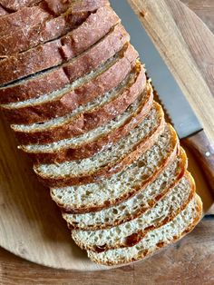 sliced loaf of bread sitting on top of a cutting board