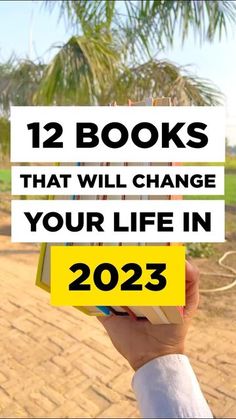 someone holding up a sign that says, 12 books that will change your life in 2013