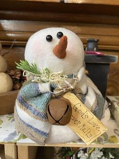 a snowman sitting on top of a wooden table