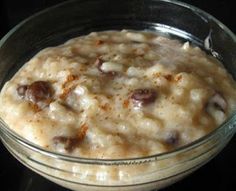 an oatmeal in a glass bowl sitting on top of a stovetop