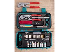 an open tool box filled with tools on top of a wooden table