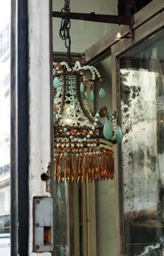 a chandelier hanging from the side of a building