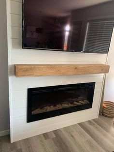 a flat screen tv mounted above a fireplace