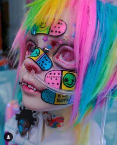 a person with colorful hair and makeup on their face