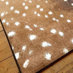 a brown rug with white spots on it