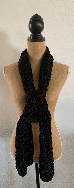 Stay warm and fashionable this fall and winter with our beautifully crocheted Black Velvet Scarf. This scarf is made with soft Bernat Velvet yarn, giving it a luxurious and cozy feel. Measuring approximately 67 inches in length and 7 inches in width, this scarf is the perfect accessory to keep your neck warm and stylish. Not only is this scarf functional, but it also makes for a great gift for anyone from teens to adults. The classic black color pairs well with any outfit, making it a versatile Crochet Womens Scarf, Bernat Velvet, Velvet Crochet, Color Pairs, Velvet Yarn, Velvet Scarf, Spring Scarves, Pink Olive, Kids Scarf