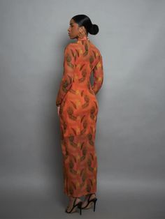 A stunning graphic print against a bold orange tulle will elicit compliments aplenty. The long-sleeve, full-length, mock turtleneck elements make this a perfect trans-seasonal option that can be worn with heels or biker boots.- Tulle, keyhole fastening at back, pearl buttons- Made in Turkey, ships from Ghana Christie Brown, African Luxury, Tops And Skirts, Tulle Midi Dress, Red Carpet Ready, Biker Boots, Mock Turtleneck, Mini Shirt Dress, Pearl Buttons