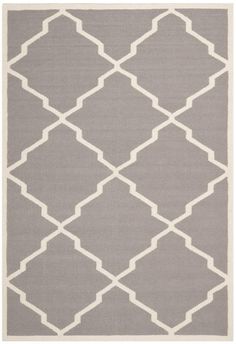 a gray and white rug with an abstract design