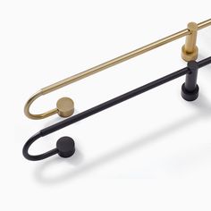 a pair of black and gold handles on a white background