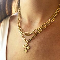 This Cross is inspired by a 7th century antique that depicted haloed saints at each end of the cross. We love the regal feel with a modern interpretation. This double layer chain in brass plated in a matte gold finish. The shorter chain is 16" and the longer chain is 17". Has a 3" extension for adjustable length. All orders over $50 ship for free within the USA. All orders usually ship within 24 hrs from the USA. Gold Elegant Metal Cross Necklace, Elegant Gold Metal Cross Necklace, Elegant Gold Cross Necklace With Chain, Elegant Gold Cross Necklace, Gold Metal Cross Necklace With Clavicle Chain, Gold Metal Cross Necklace With Adjustable Chain, Gold Brass Cross Jewelry, Gold Brass Cross Pendant Necklace, Gold Metal Crucifix Cross Necklace