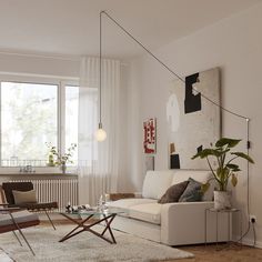 a living room filled with furniture and a large window covered in white curtained curtains