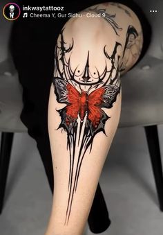 a woman's leg with tattoos on it and a red butterfly in the middle