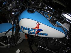 a blue and white harley davidson motorcycle parked in a garage